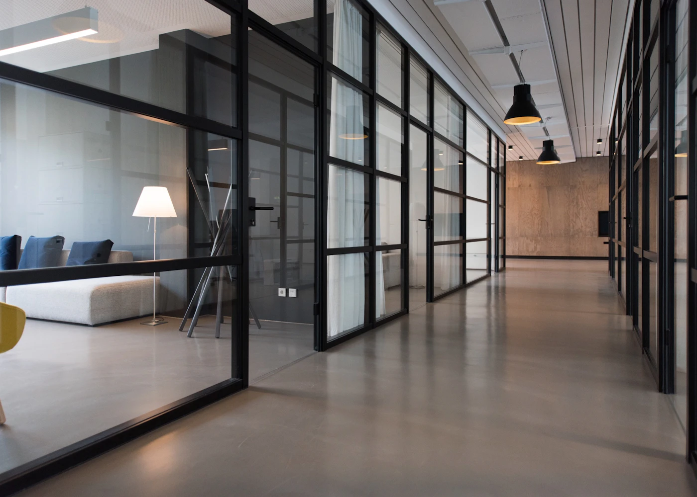 Modern office with glass meeting rooms and shared work areas